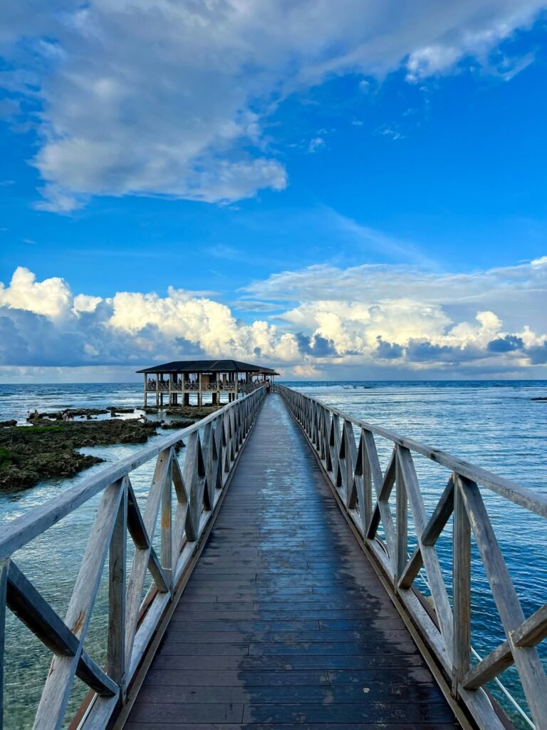 jess-silaya-QQmcdhERpMo-unsplash Surfers and onlookers at the Cloud 9 surf break boardwalk in General Luna, Siargao, Philippines.